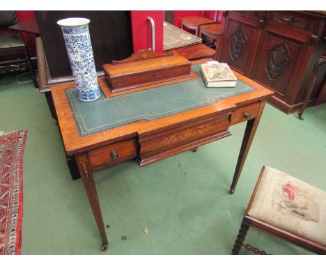 An early Victorian inlaid rosewood breakfront writing desk, the raised hinged lid stationery cabinet with key, over a gilt to