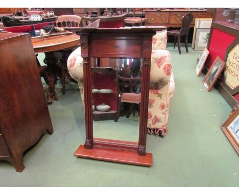 A Regency style bevelled edge mahogany pier mirror with black line inlay and tri-turned column decoration over a base shelf, 