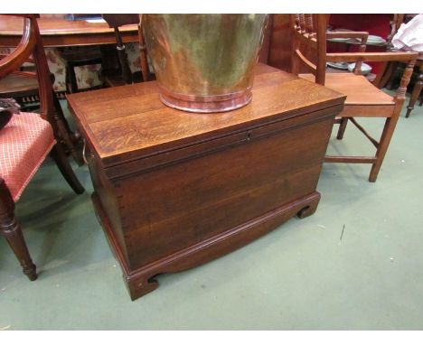 A George III oak chest the hinged lid and brass carrying handles over bracket feet with lidded internal candle box, 57cm wide