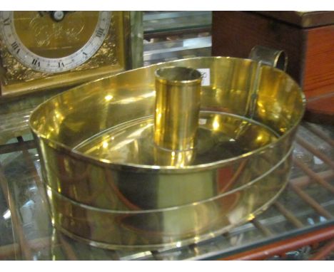An Arts &amp; Crafts brass chamber stick, 20.5cm wide