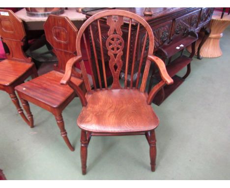 An elm and oak stick back Windsor elbow chair circa 1840 the hoop back with wheel central splat over an elm seat and curved a