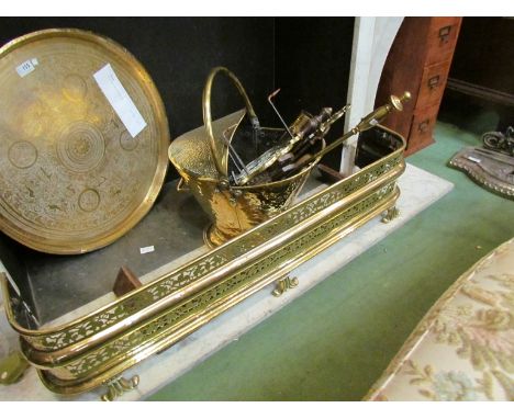 A brass coal scuttle and fire tools, tool holder, trivet and two fenders 