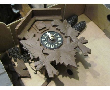 A small modern cuckoo clock in a wood-effect resin case, hand a/f