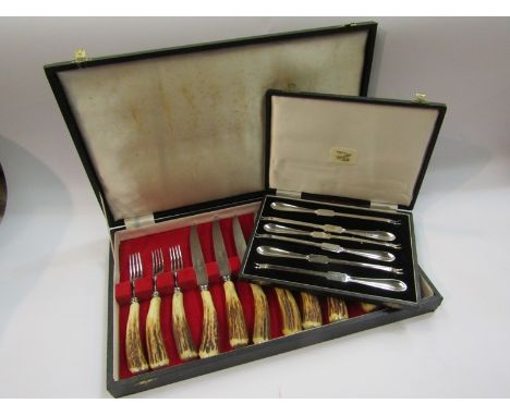 A cased 12 piece horn handled knife and fork set, together with a cased set of six lobster picks