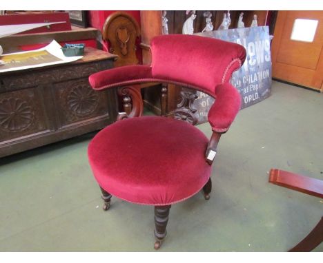 A Victorian walnut elbow chair with wheel-back, ring turned legs 
