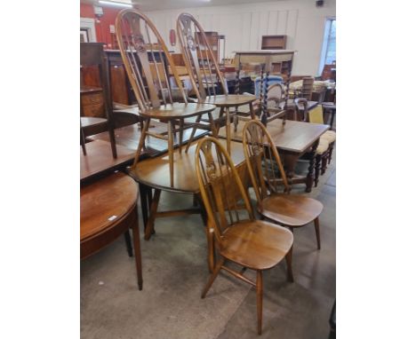 An Ercol Golden Dawn elm dropleaf dining table and four swan back Quaker chairs 