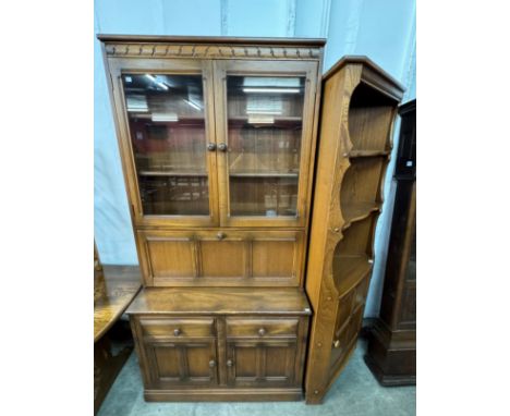 An Ercol Golden Dawn elm bookcase and a freestanding corner cupboard 