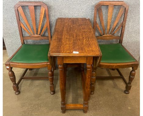 An early 20th Century oak bobbin turned gateleg table and a pair of Art Deco oak dining chairs 