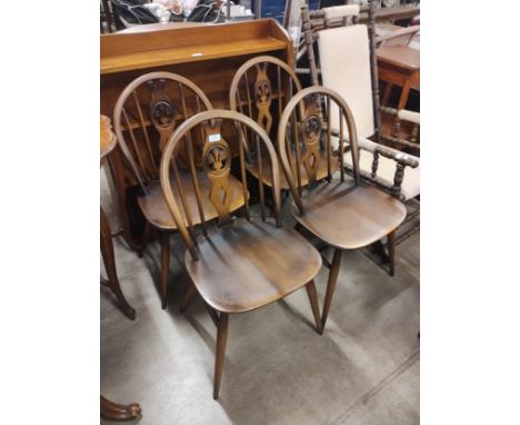 A set of four Ercol Golden elm and beech fleur de lys chairs 
