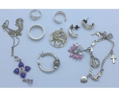 A silver and lavender jade pendant and chain, a silver charm bracelet, silver pendants, earrings, etc.