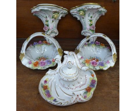 Five German porcelain floral encrusted items; an inkwell, a pair of wall brackets and a pair of baskets (5)