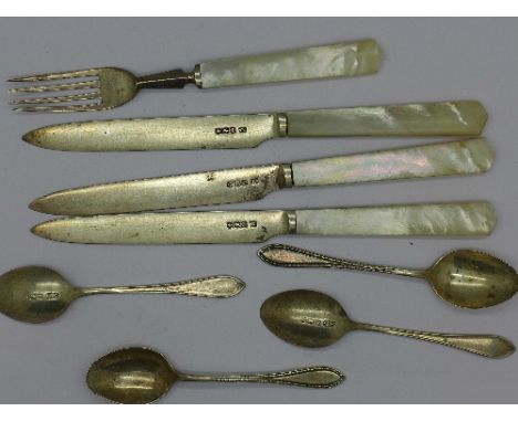 A collection of silver cutlery; four spoons, three dessert knives and a fork