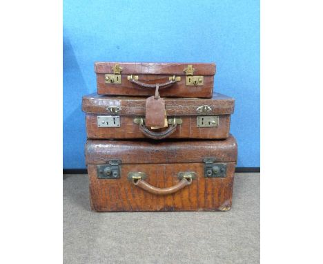 Early 20th Century crocodile skin travelling trunk (a/f) together with two further crocodile skin leather suitcases