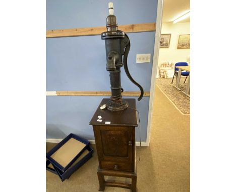 An unusual Simon Simpson of Norwich combination lamp and side cabinet, the lamp formed from a vintage iron water pump mounted