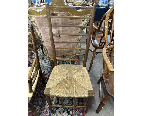 An Arts &amp; Crafts style rush seat ladder back chair, 100cm high
