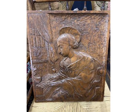 20th Century carved oak panel depicting a lady playing a piano, initialled 'AW' to the reverse, 37 x 46cm 