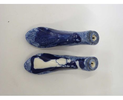 A unusual pair of late 19th/early 20th Century ceramic boot warmers, both with Aubrey Beardsley style Art Nouveau prints to t