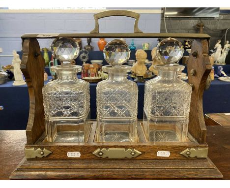 Oak and silver plate mounted three bottle tantalus, 40cm wide