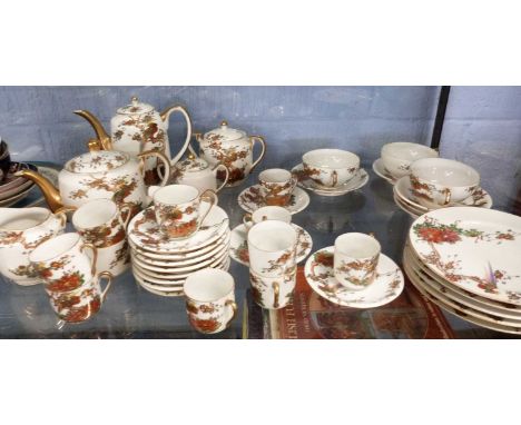 An early 20th Century Japanese porcelain tea and coffee set decorated with a polychrome design of pheasants on branches, set 