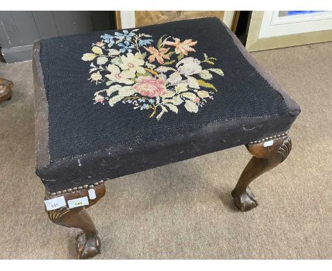 A Georgian style stool of rectangular form with tapestry top raised on cabriole legs with ball and claw feet, 58cm wide