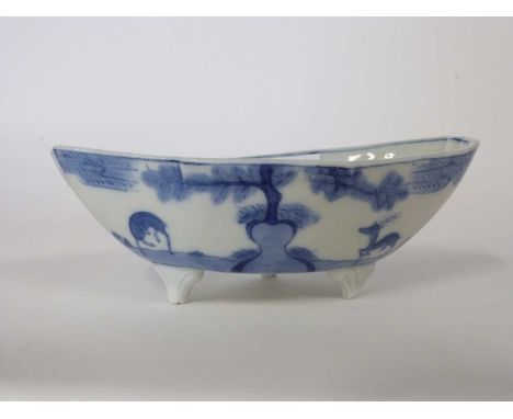Oriental porcelain sauceboat, 19th Century, raised on three stub feet, decorated with figures and animals