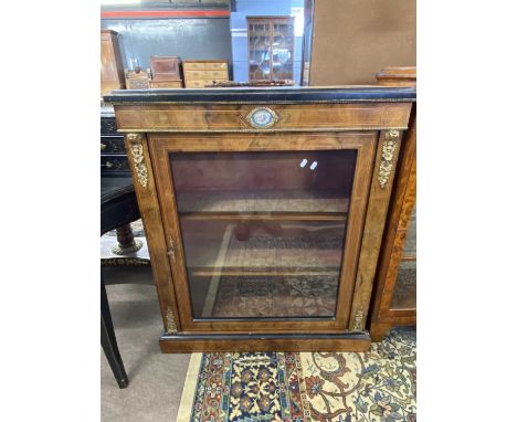 Victorian walnut veneered single doored display cabinet with applied metal mounts and central porcelain panel, 87cm wide, 34c