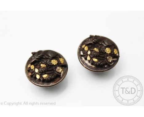 A pair of Japanese Shakudo studs, Meiji Period (1868-1912) each in mixed metal and designed as a stag upon a rocky outcrop, u
