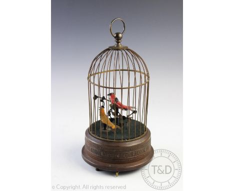 A clockwork musical automaton, the domed brass enclosure with two birds upon branches within, on three feet and with swivel h