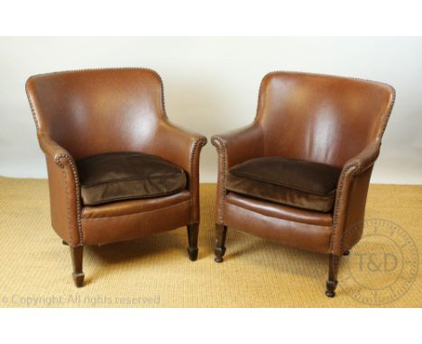 A pair of early 20th century board room tub chairs, c1910, with faux leather upholstery on tapered oak legs 79cm H CONDITION 