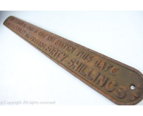 A reproduction cast iron LNER railway sign, titled 'Any person who omits to shut and fasten this gate is liable to a penalty 