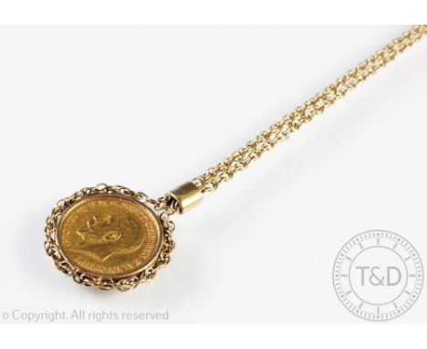 A George V gold half sovereign dated 1912, within yellow metal mount and chain surround, attached 9ct gold rope twist chain s