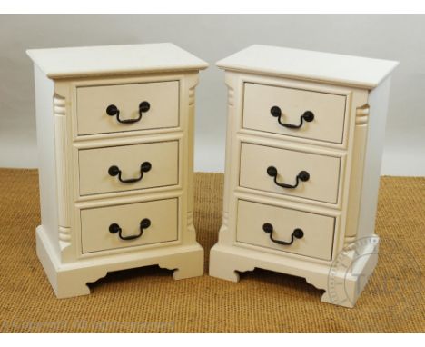 A pair of modern painted white bedside chests, with three drawers on bracket feet. 67cm H x 46cm W x 43cm D.