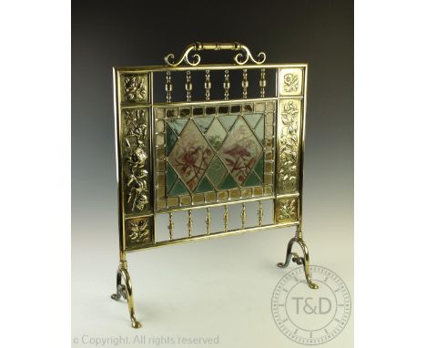 A 19th century Aesthetic brass and stained glass fire screen, the glass decorated with birds, within a border of different fl