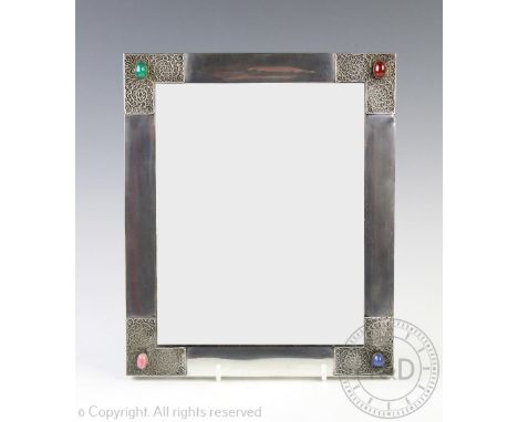 A Russian silver frame, the rectangular frame set to each corner with coloured cabochon stones within a filigree surround, se