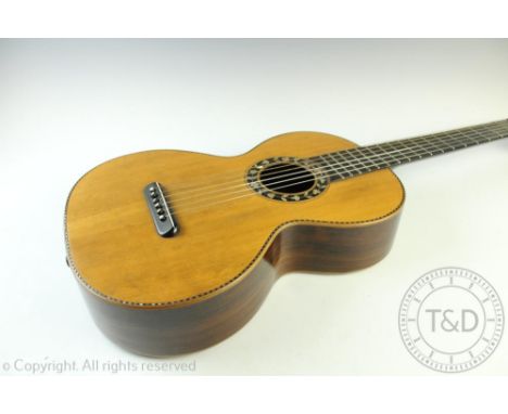 A 19th century parlour guitar, with floral mother of pearl detailing, rosewood sides and back, the brass fittings for the gea