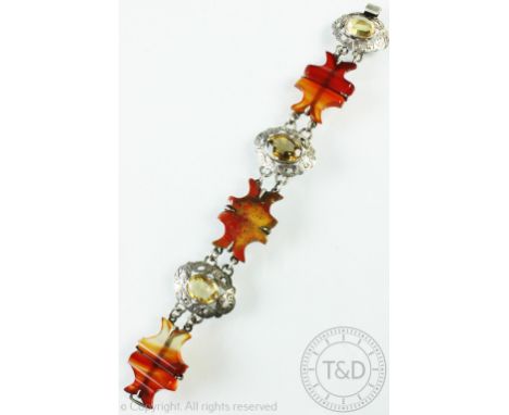 A Victorian agate and citrine set bracelet, designed as three carved agate panels interspersed with three white metal oval li