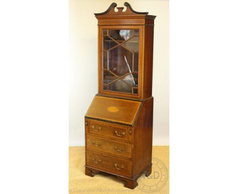 An Edwardian mahogany and satinwood inlaid cabinet bureau, with broken swans neck pediment and astragal glazed door, above fa