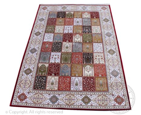 A Kashmir type bamboo silk carpet, worked with a Persian panel or garden design with arches, trees and flowers, 302cm x 119cm