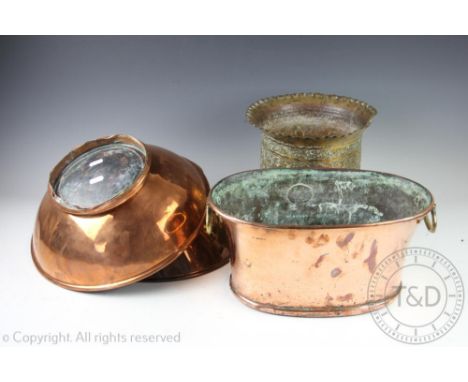 A 19th century copper and brass handled planter, of oval form, 39cm wide, with a near pair of copper centre bowls, each 35cm 