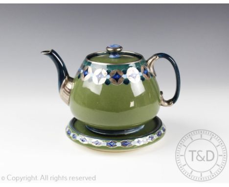 A William Moorcroft for Macintyre teapot, cover and stand, green glazed throughout and with a band of stylised silver lustre 