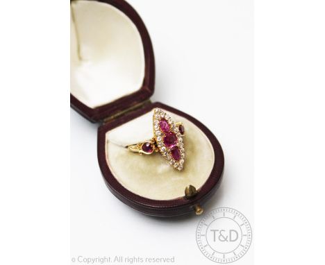 A Victorian ruby and diamond ring, London 1895, the marquise shaped ring designed as three graduated rubies, within an old cu