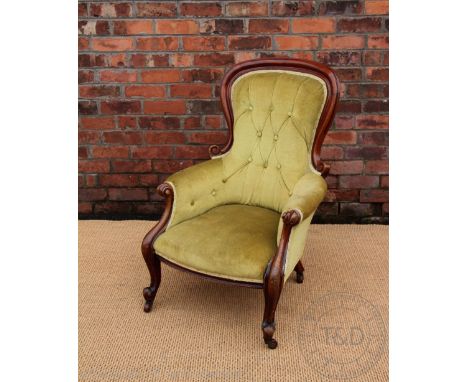 A Victorian carved mahogany salon chair, with button back green upholstery on cabriole legs 105cm H