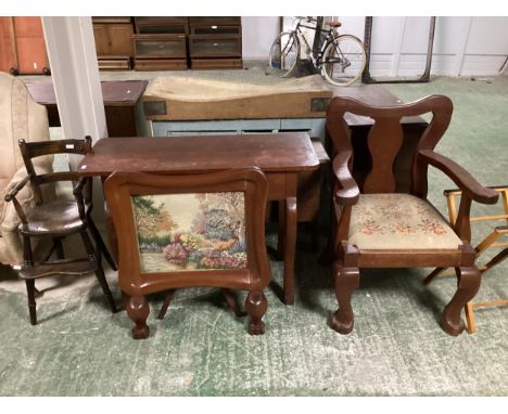 An oversized large wooden arm chair, with tapestry seat and a childs high chair 