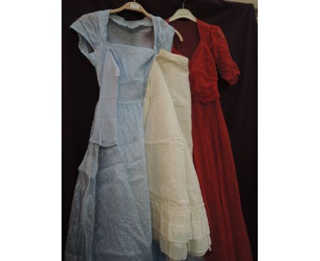 A ladies vintage pale blue organza evening dress with small white dots having blue underslip, underskirt and gloves, and a re