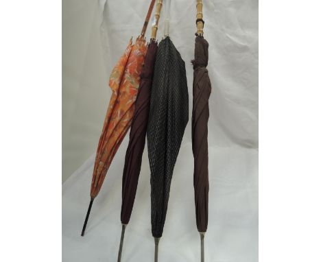 Four vintage umbrellas and parasols, two having cane handles