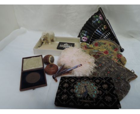 A small selection of miscellaneous items including a feather fan, treen nutmeg grater, sandstone elephant and three vintage b