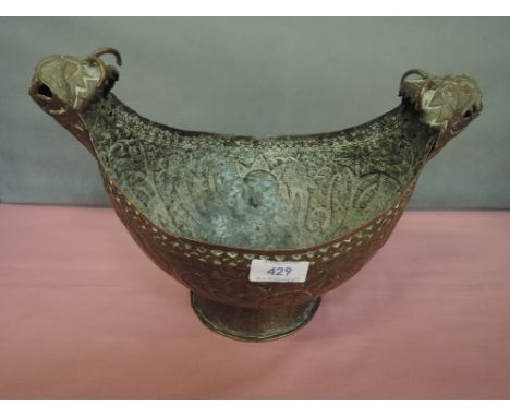 A vintage brass dish of Kovosh design having extensive beaten decoration and mythological handles