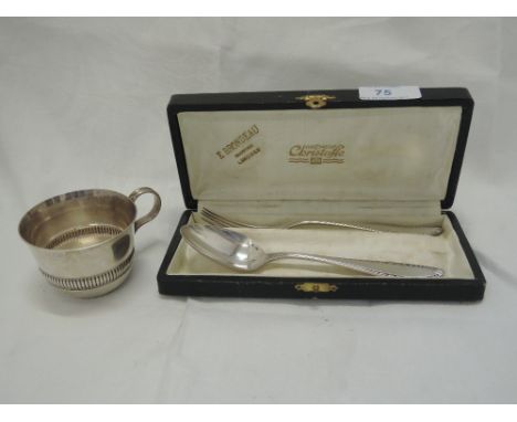 A cased French silver spoon and fork set having decoration to terminals, Christofle, and a small white metal cup bearing Fren