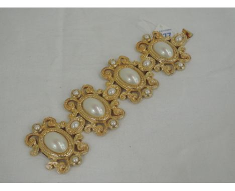 A 1980's oversized simulated pearl and gilt  articulated bracelet by Christian Dior   
