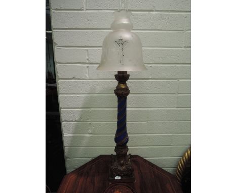 A 19th century cast oil lamp base having ornate Rococo style relief with blue ceramic wrythen column and etched glass shade